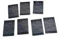 Set of black notebooks with 'heartbeat' text on a black surface with lines and a heart in the background